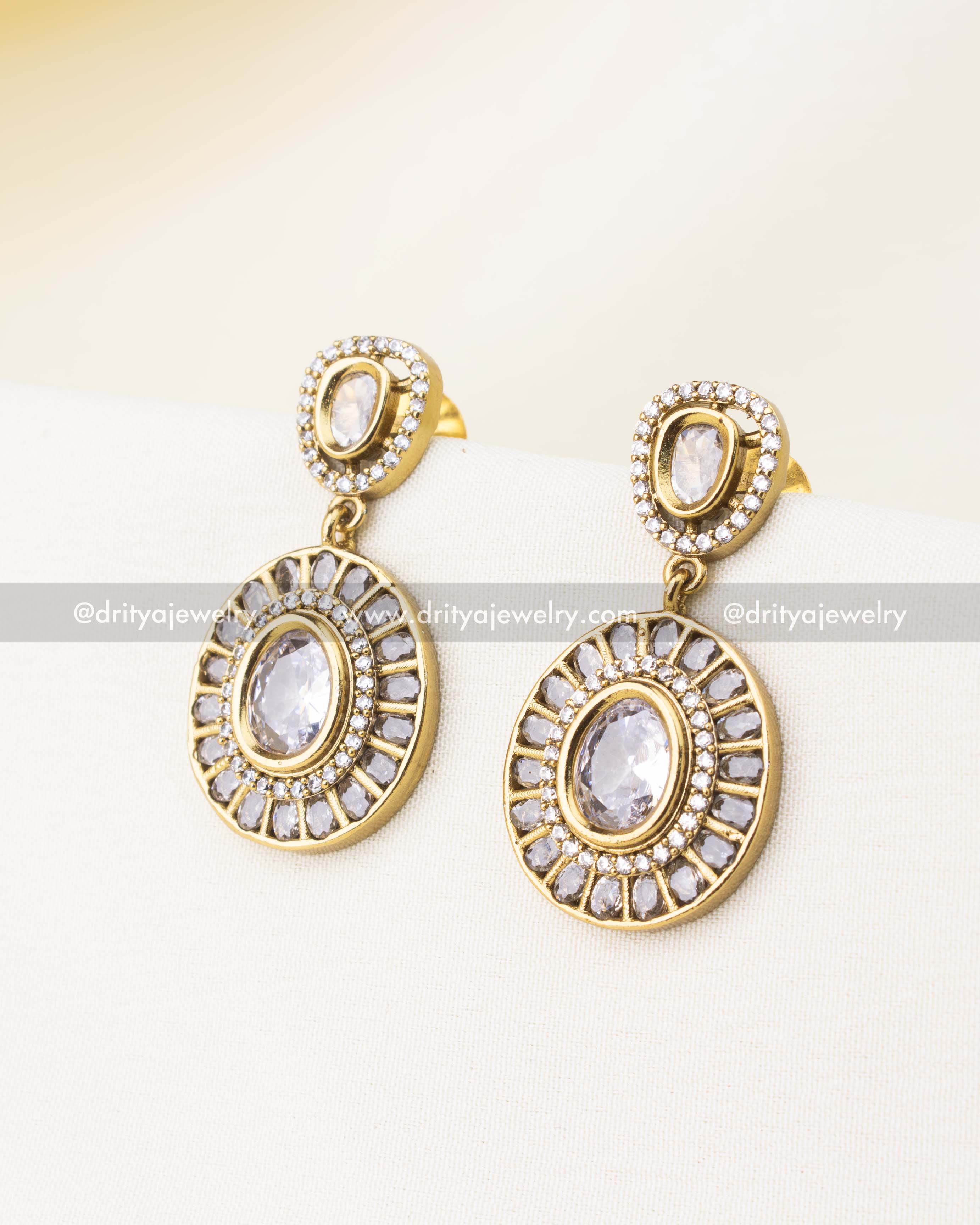 White stone earrings with circular diamond frame