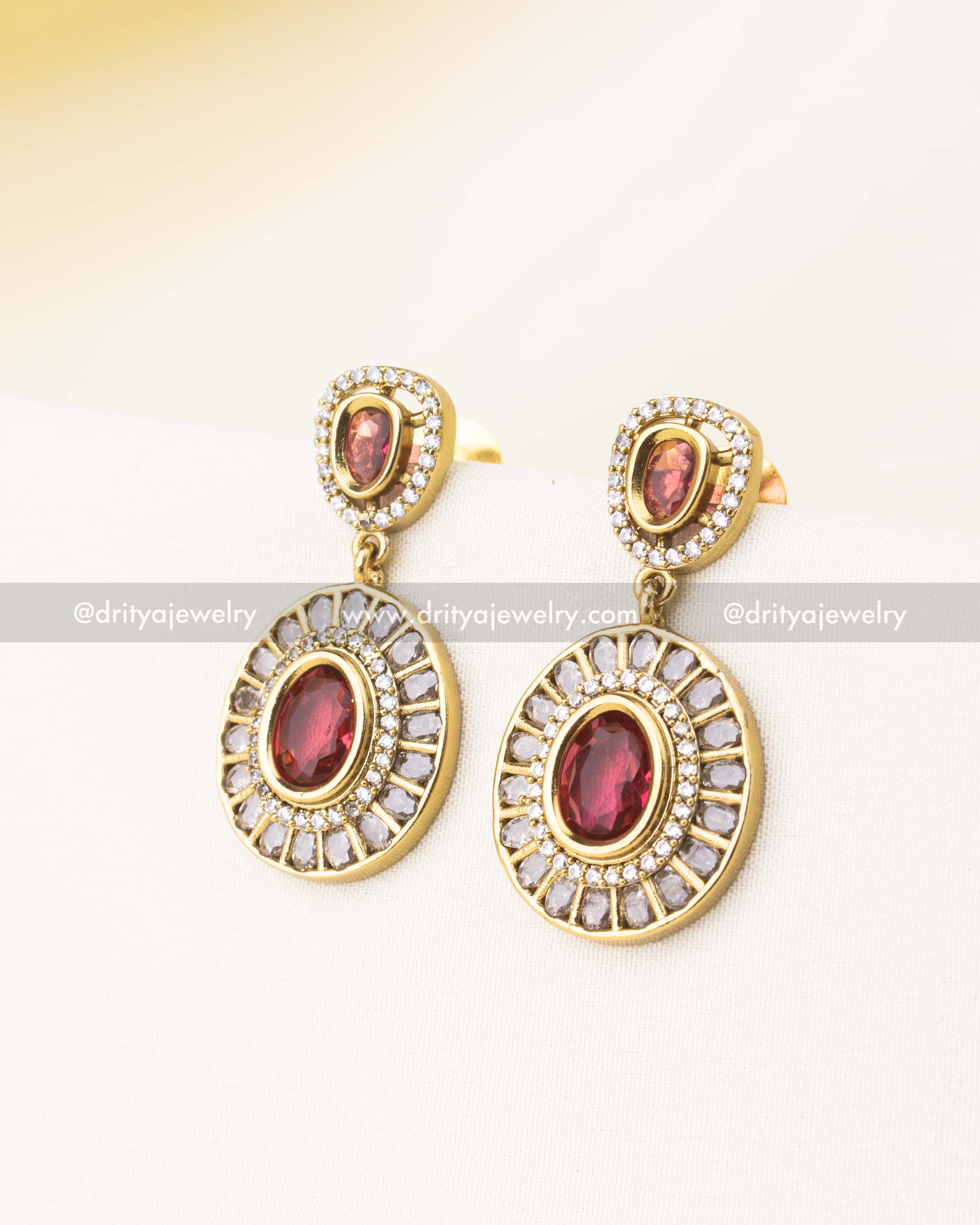 Matching red stone and diamond-studded drop earrings