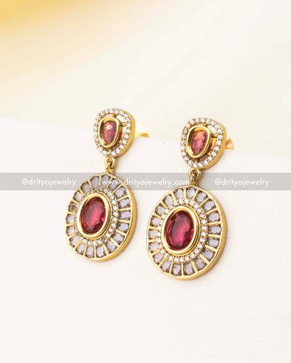 Matching red stone and diamond-studded drop earrings