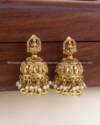 Nakshi temple jhumkas with CZ detailing and pearl-gold hangings.