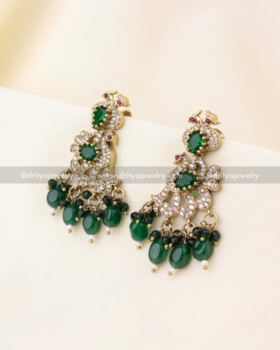 Matching peacock design drop earrings with green beads and CZ stones