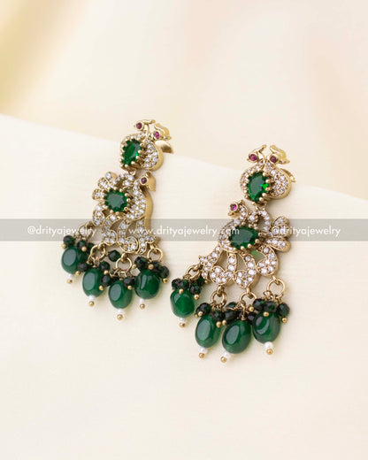 Matching peacock design drop earrings with green beads and CZ stones