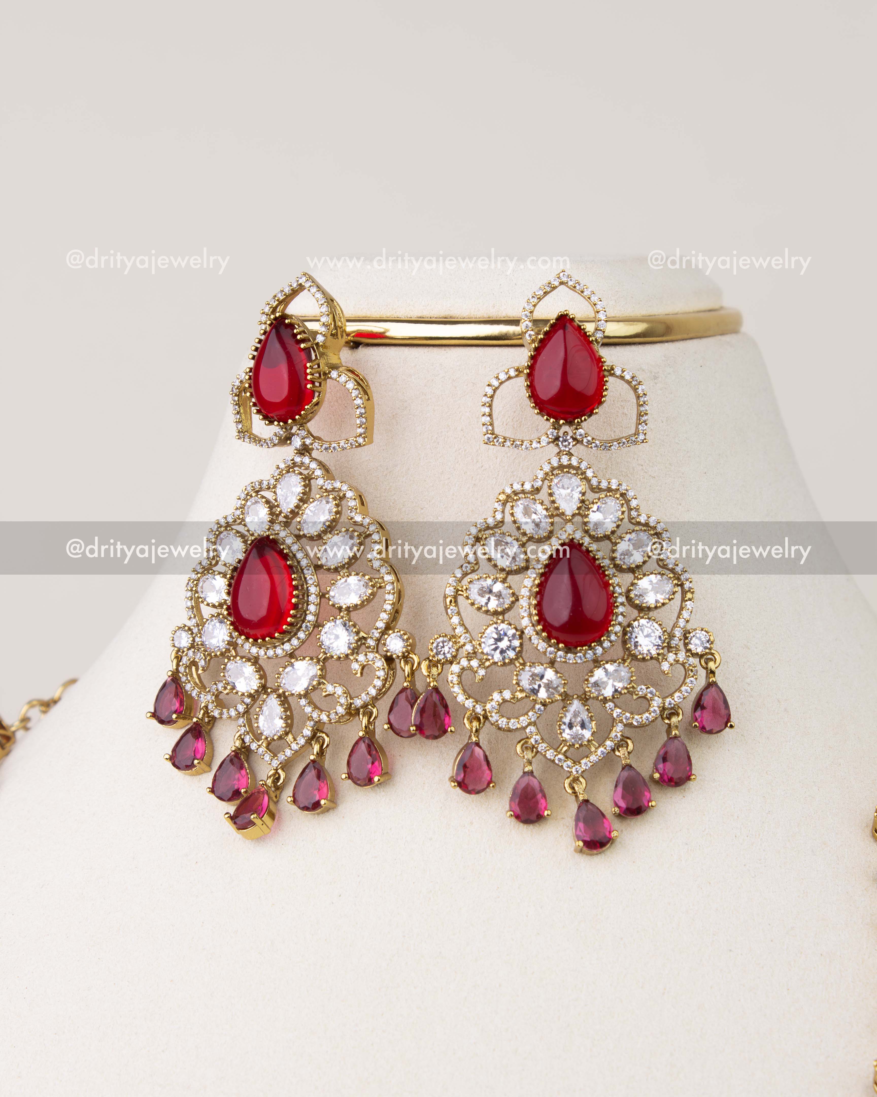 Victorian earrings with red stones, CZ accents, and drop detailing
