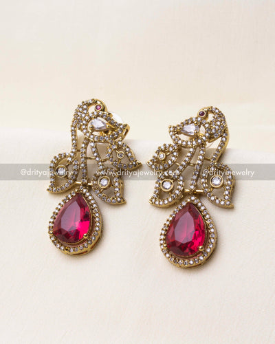 Intricate detailing of the peacock motif with ruby red centerpiece in Victorian finish.