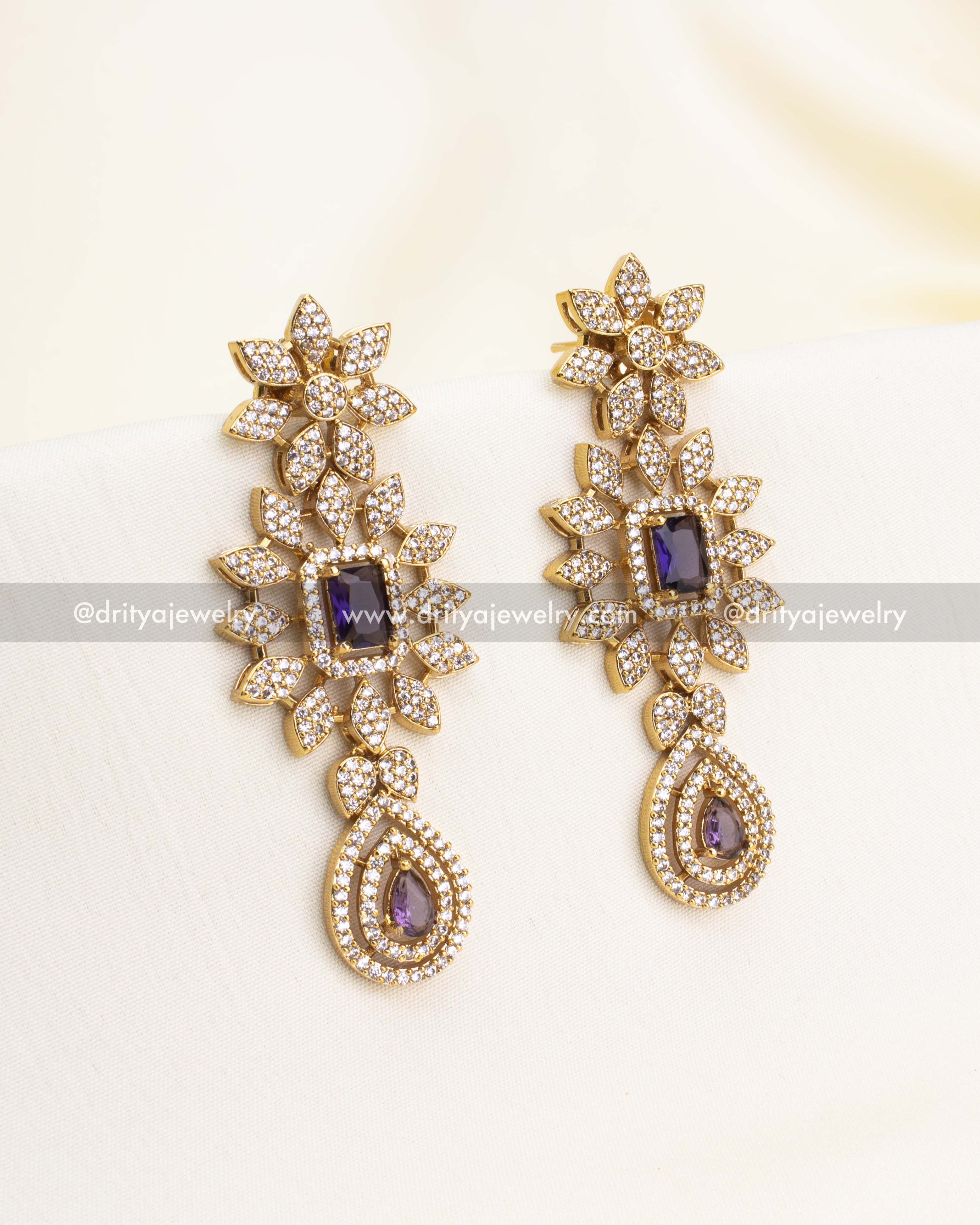 Floral earrings with amethyst center stones and CZ encrusted drops.