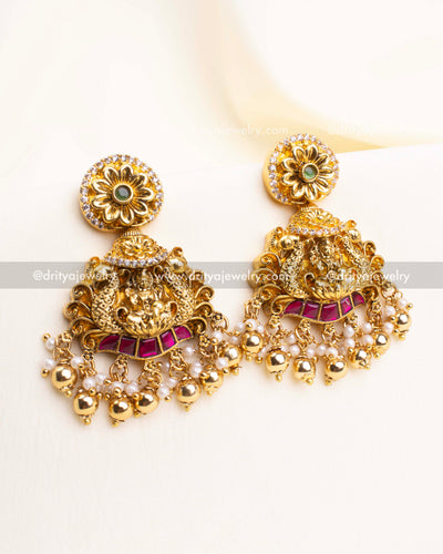 Matching earrings featuring floral tops, Lakshmi motifs, and gold bead drops.