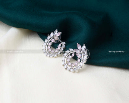 Circular zircon earrings with blush pink marquise stones and silver-tone detailing.