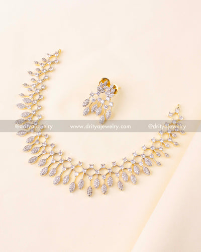 Elegant necklace set with sparkling CZ stones and golden GJ polish, paired with matching drop earrings.