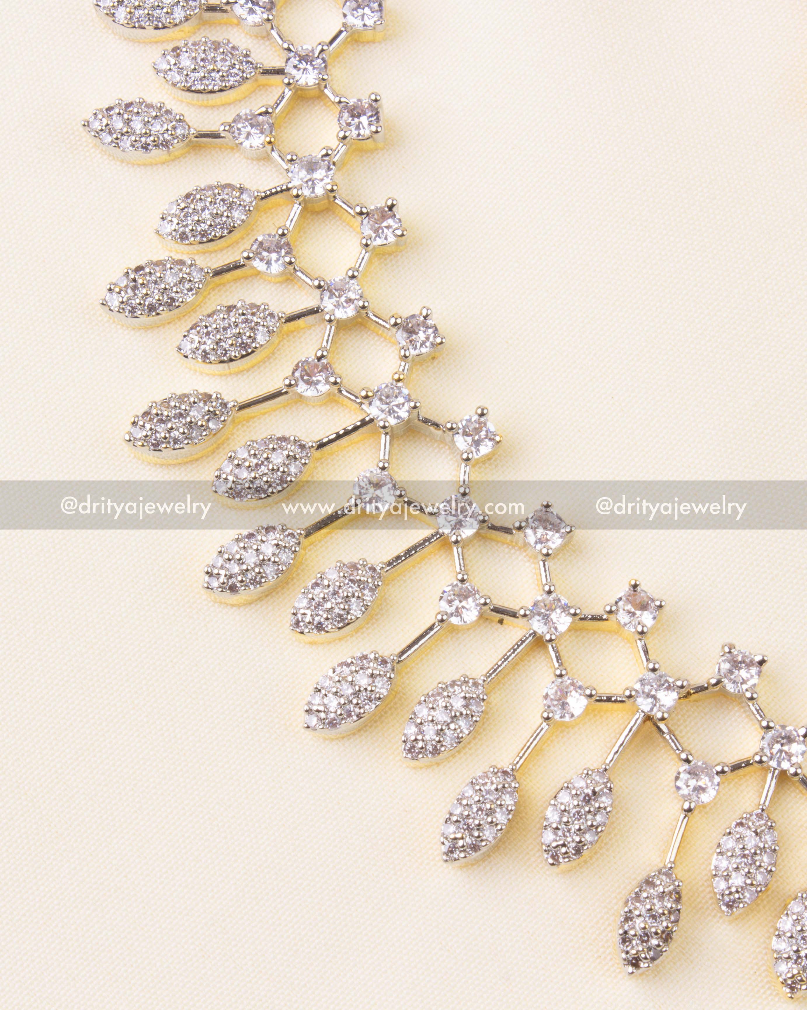 Elegant necklace set with sparkling CZ stones and golden GJ polish, paired with matching drop earrings.