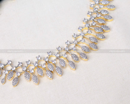 Elegant necklace set with sparkling CZ stones and golden GJ polish, paired with matching drop earrings.