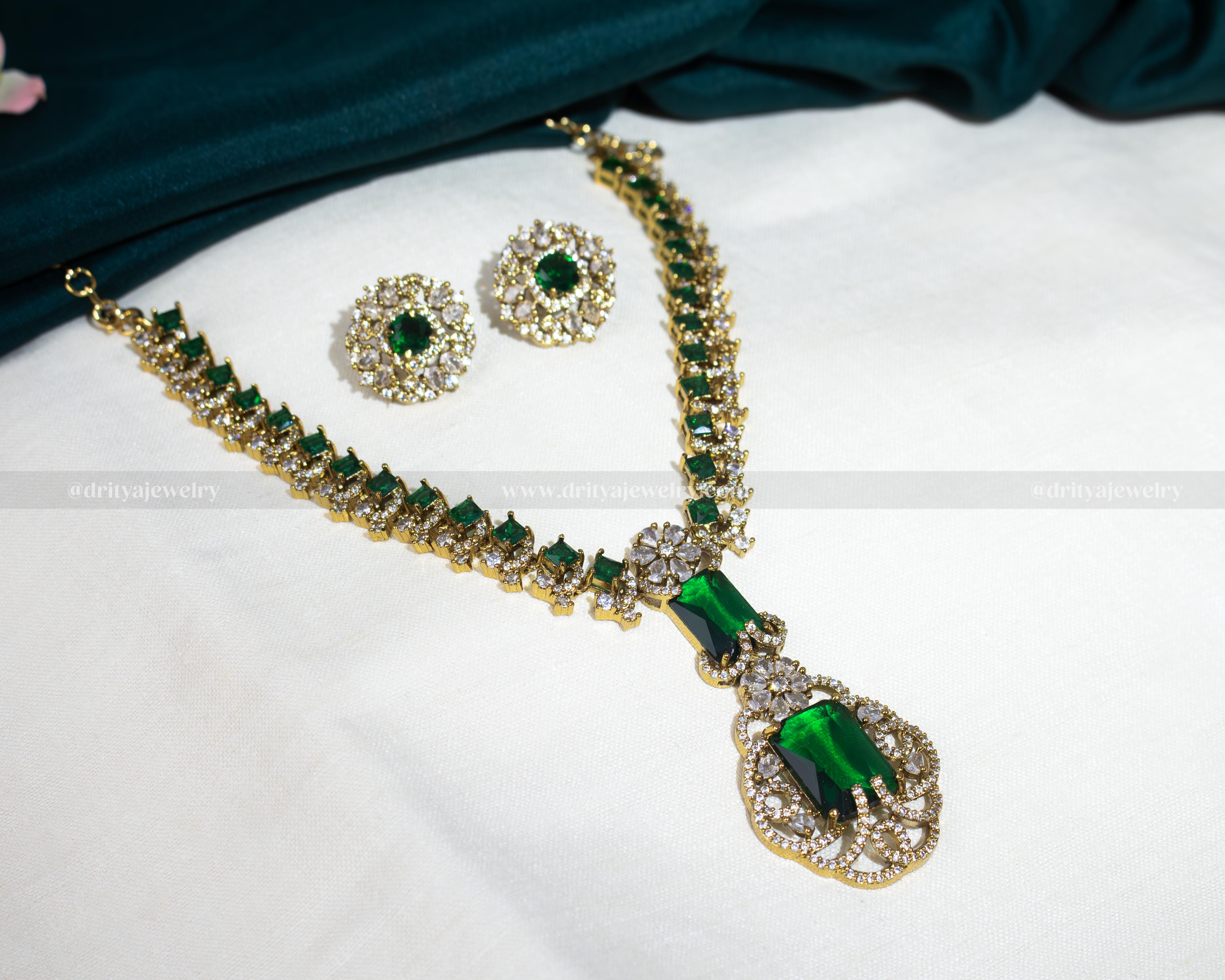 Dritya Jewelry's Elegant Dual Color CZ Necklace Set in emerald and purple, perfect for enhancing evening or bridal wear with exquisite style.