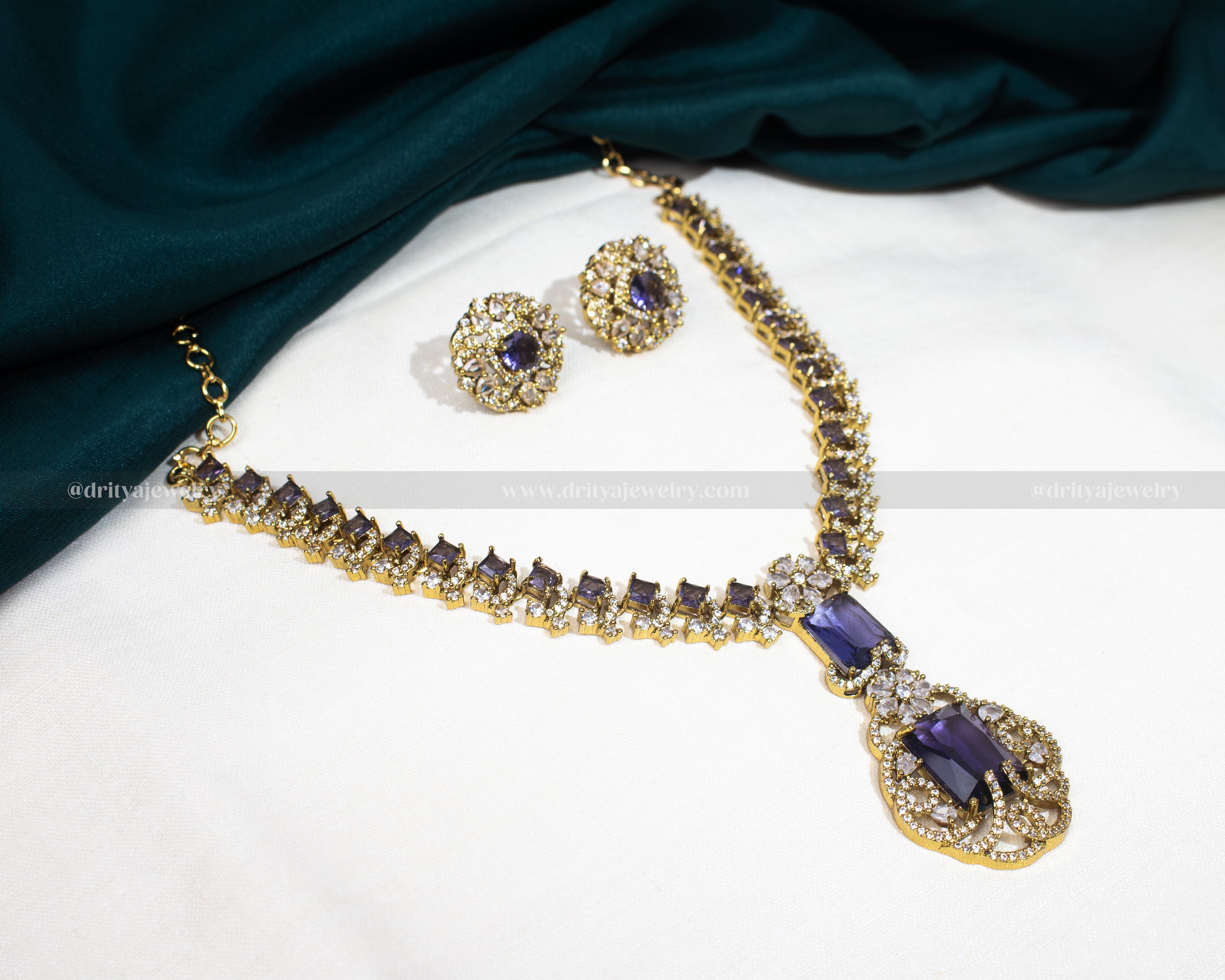 Dritya Jewelry's Elegant Dual Color CZ Necklace Set in emerald and purple, perfect for enhancing evening or bridal wear with exquisite style.