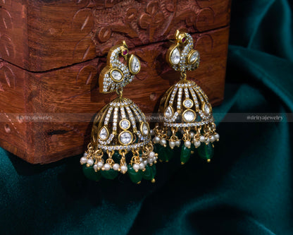 Luxurious emerald green Victorian jhumka earrings with faux gemstones and pearl accents, perfect for weddings and cultural festivities.