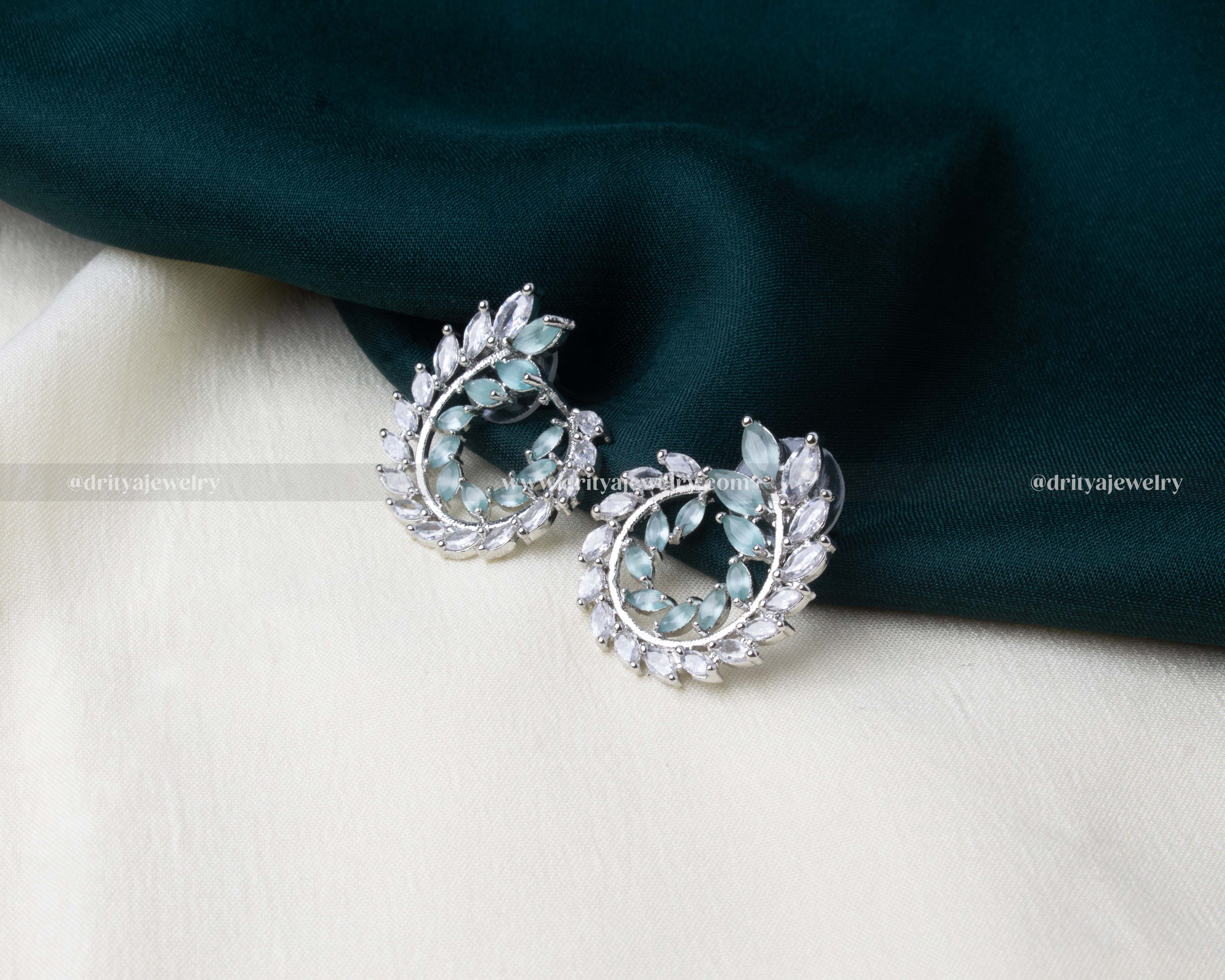 Mint green zircon earrings designed in a leaf motif with sparkling CZ stones.