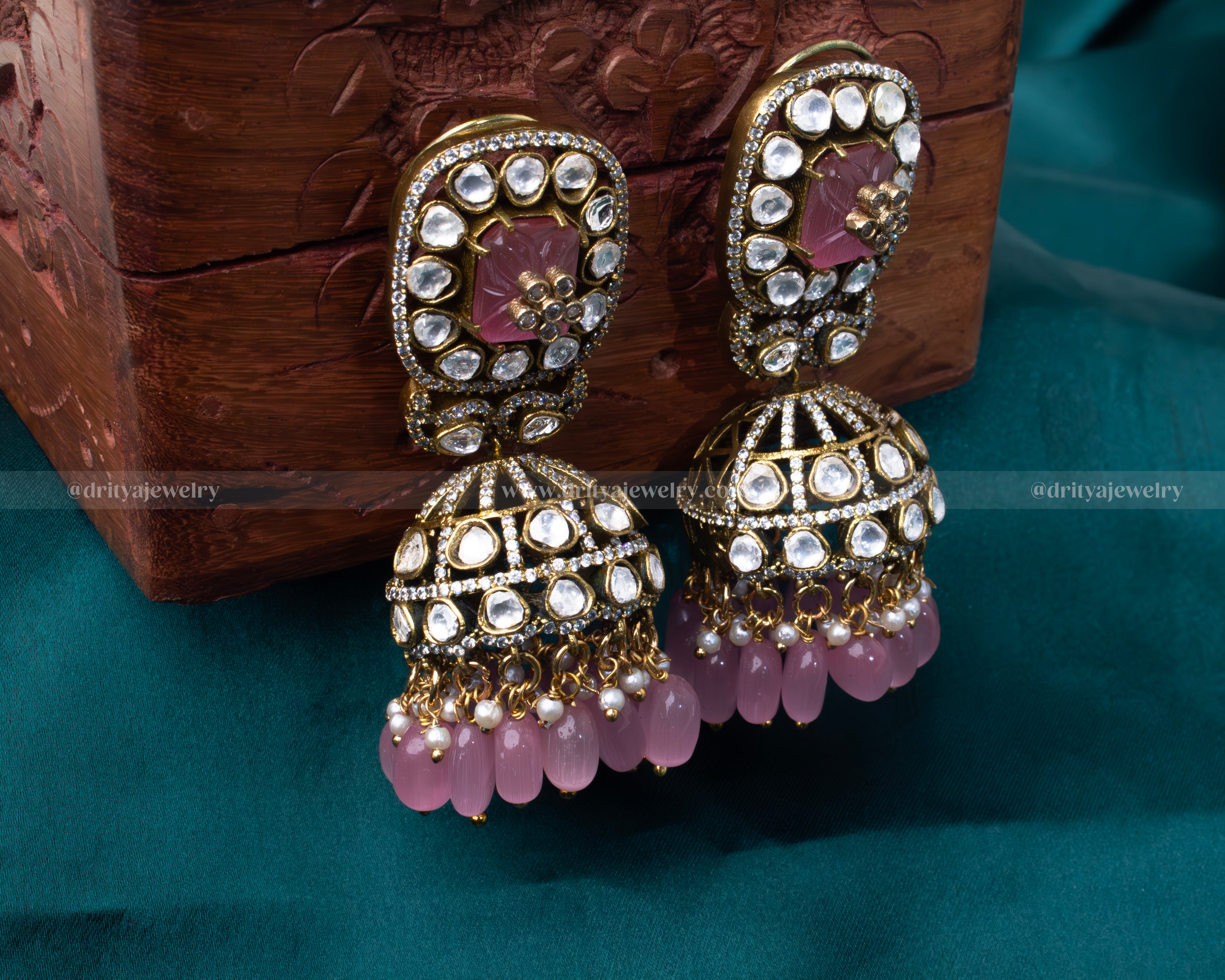 Traditional Victorian-inspired Jhumka earrings with uncut Kundan stones and pink droplets, perfect for bridal and festive wear.