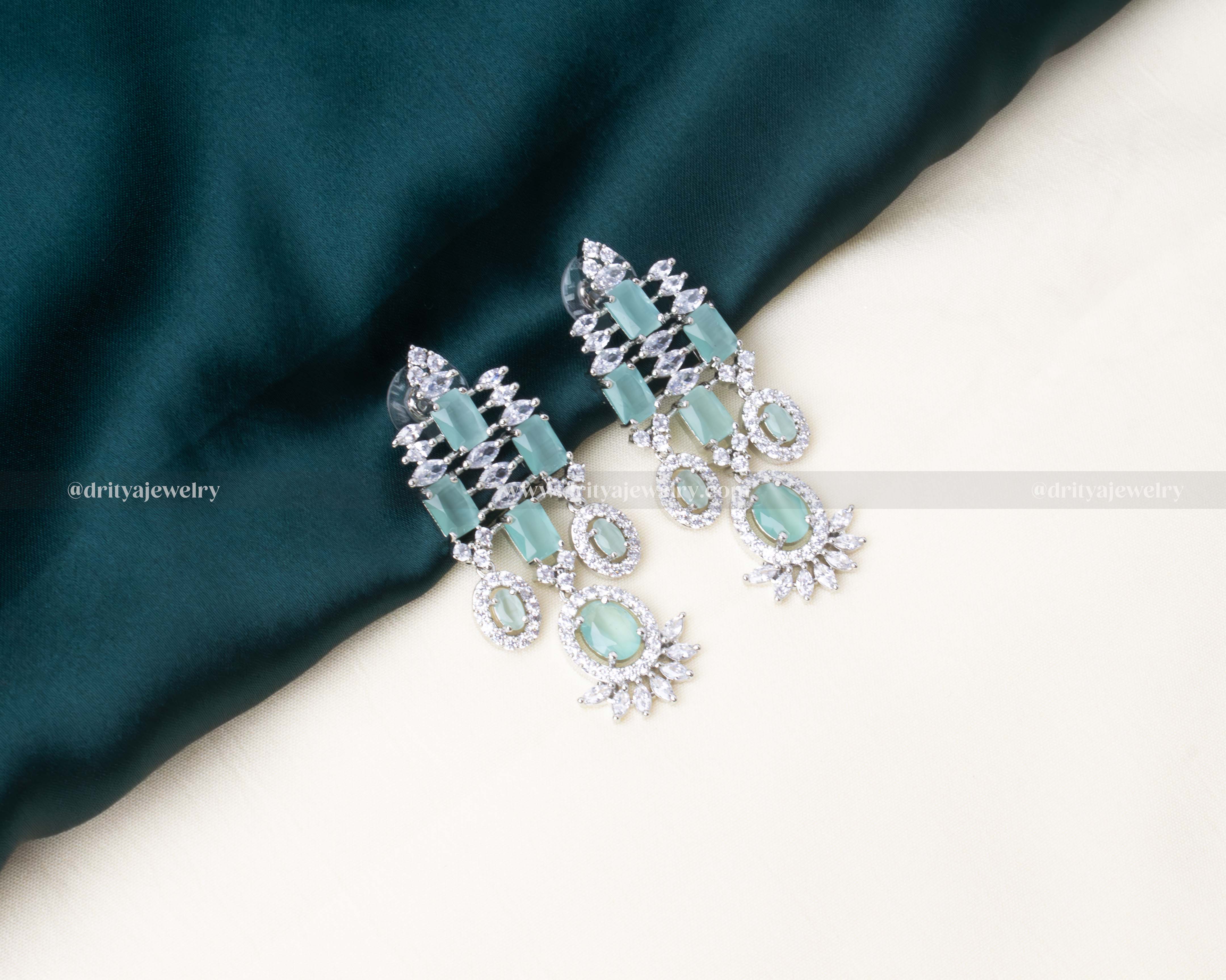 Elegant aqua blue zircon necklace set with matching earrings and a maang tikka, featuring AD stones in a radiant silver finish.