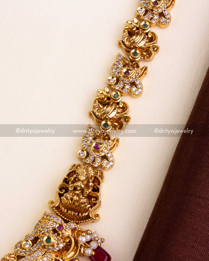 Temple chain design with carved elephants, Lakshmi Devi figures, CZ work, and ruby red stones.