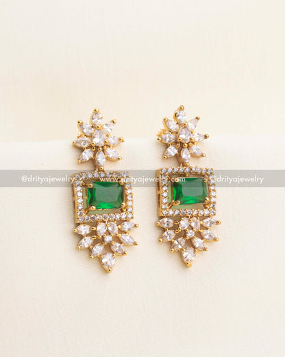Matching earrings featuring emerald green stone and floral CZ arrangements.