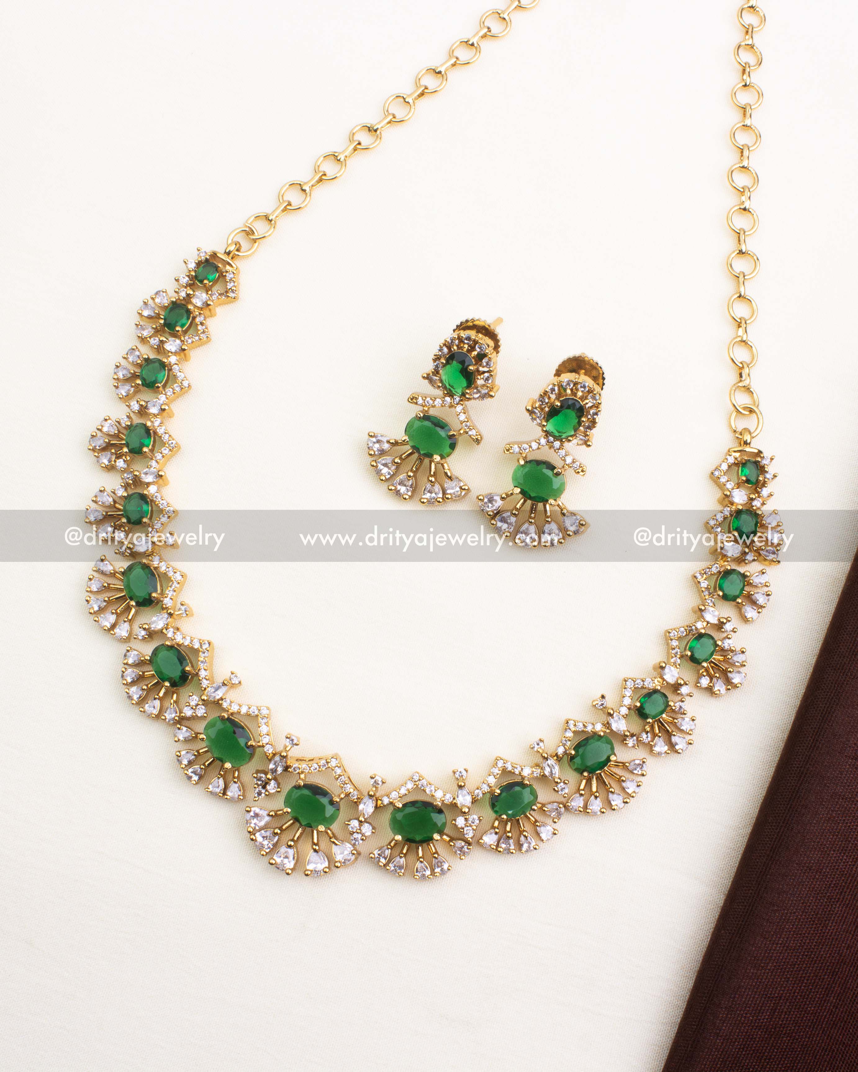 Premium emerald green short necklace set with CZ stones and radiant gold polish.