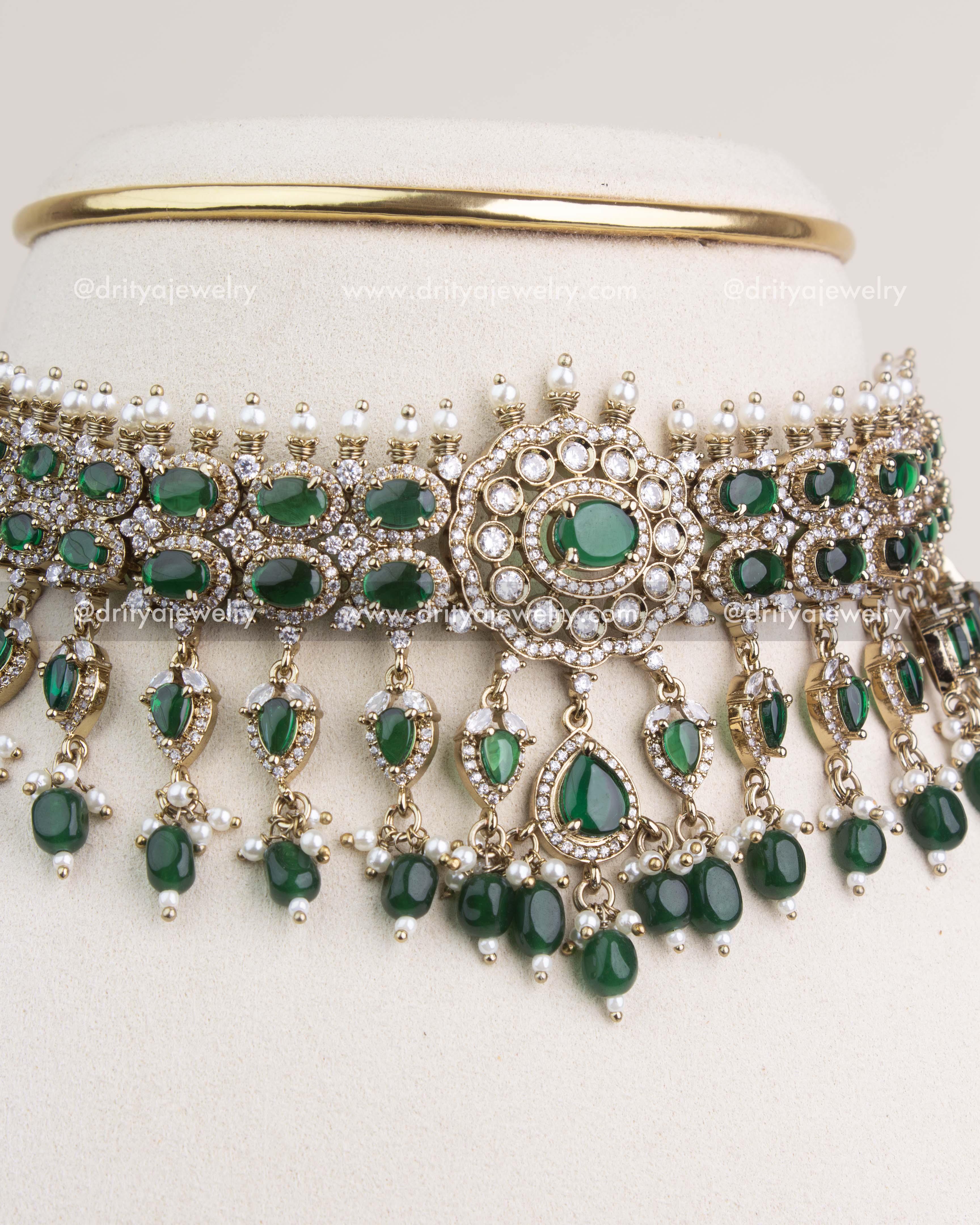 Close-up of emerald green Victorian choker with circular centerpiece and dangling pearls.