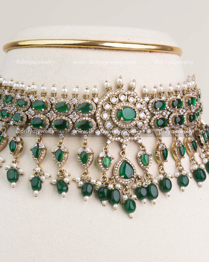 Close-up of emerald green Victorian choker with circular centerpiece and dangling pearls.