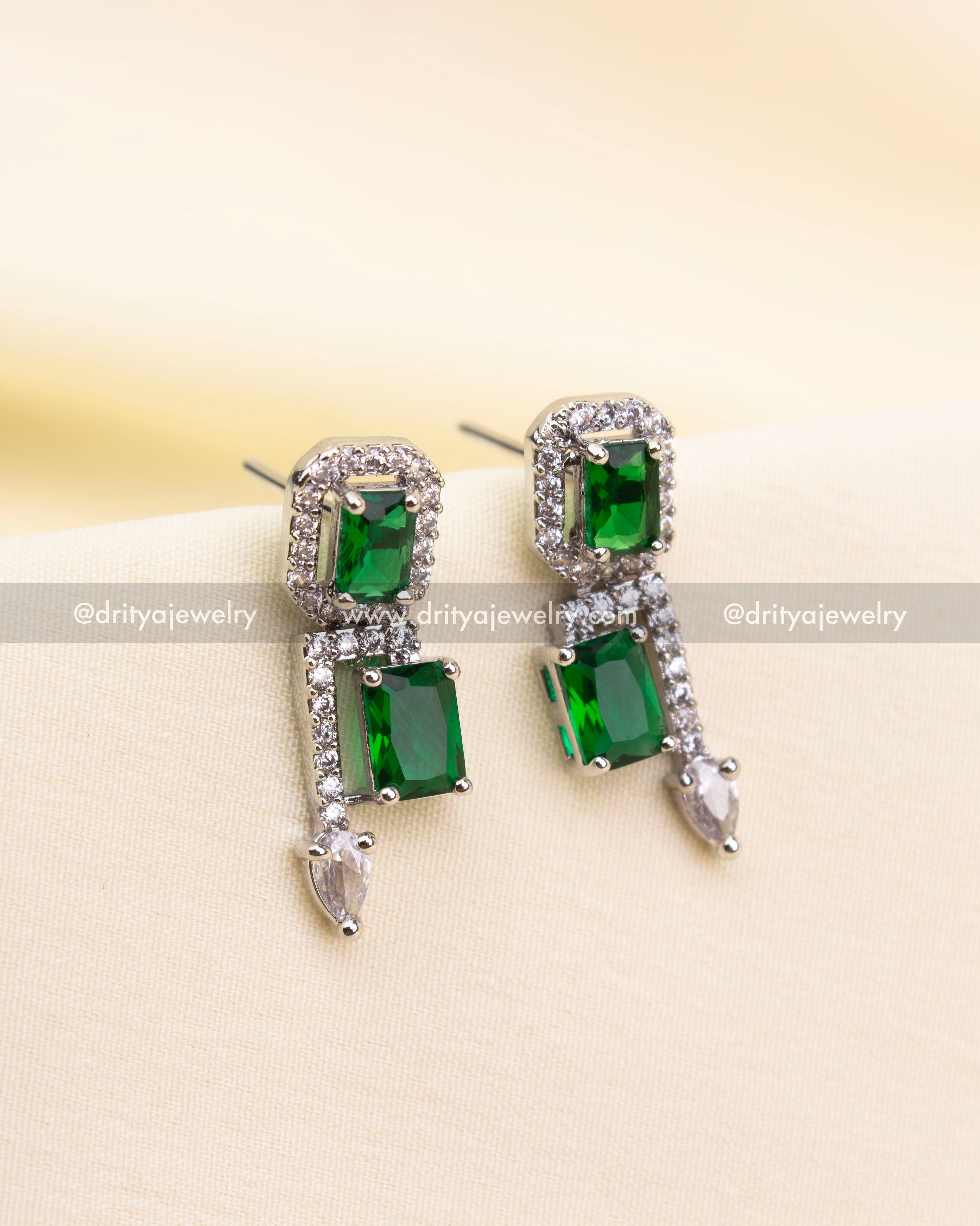 Matching green and silver earrings with rectangular stones and pointed CZs