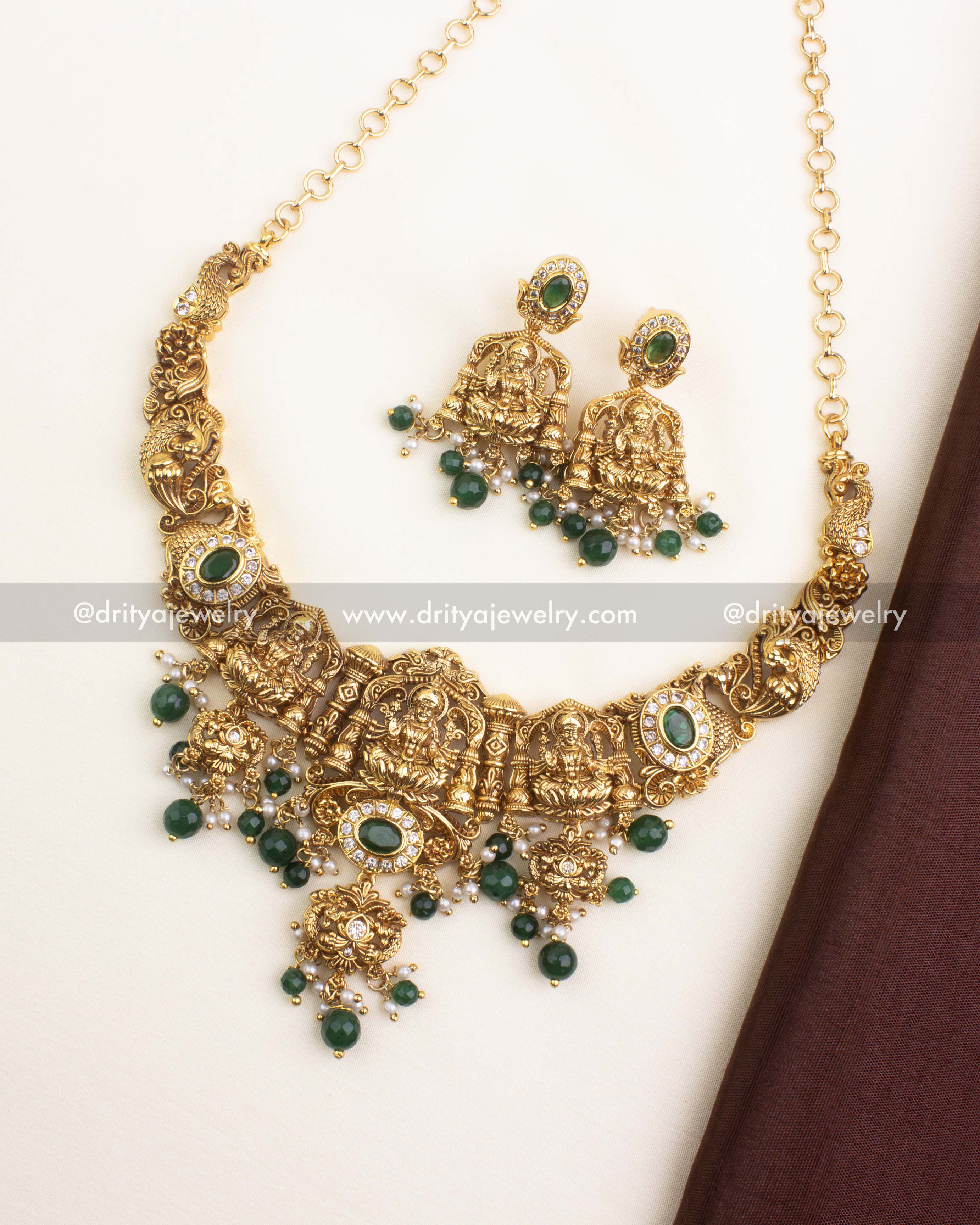 Nakshi short necklace with Goddess motifs, emerald green beads, and antique gold finish.