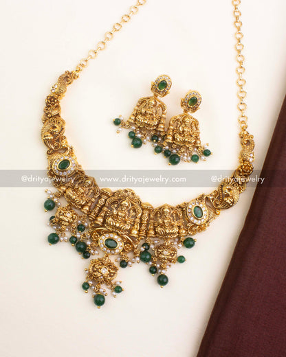 Nakshi short necklace with Goddess motifs, emerald green beads, and antique gold finish.