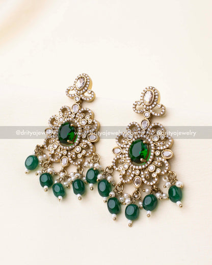 Regal Victorian earrings with emerald green stones and bead detailing.