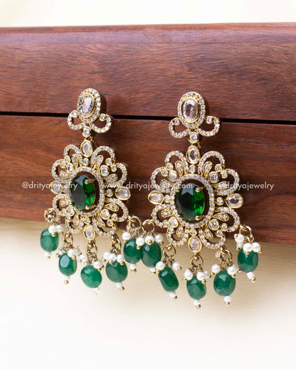 Emerald-toned drop earrings with antique gold finish and CZ stones.