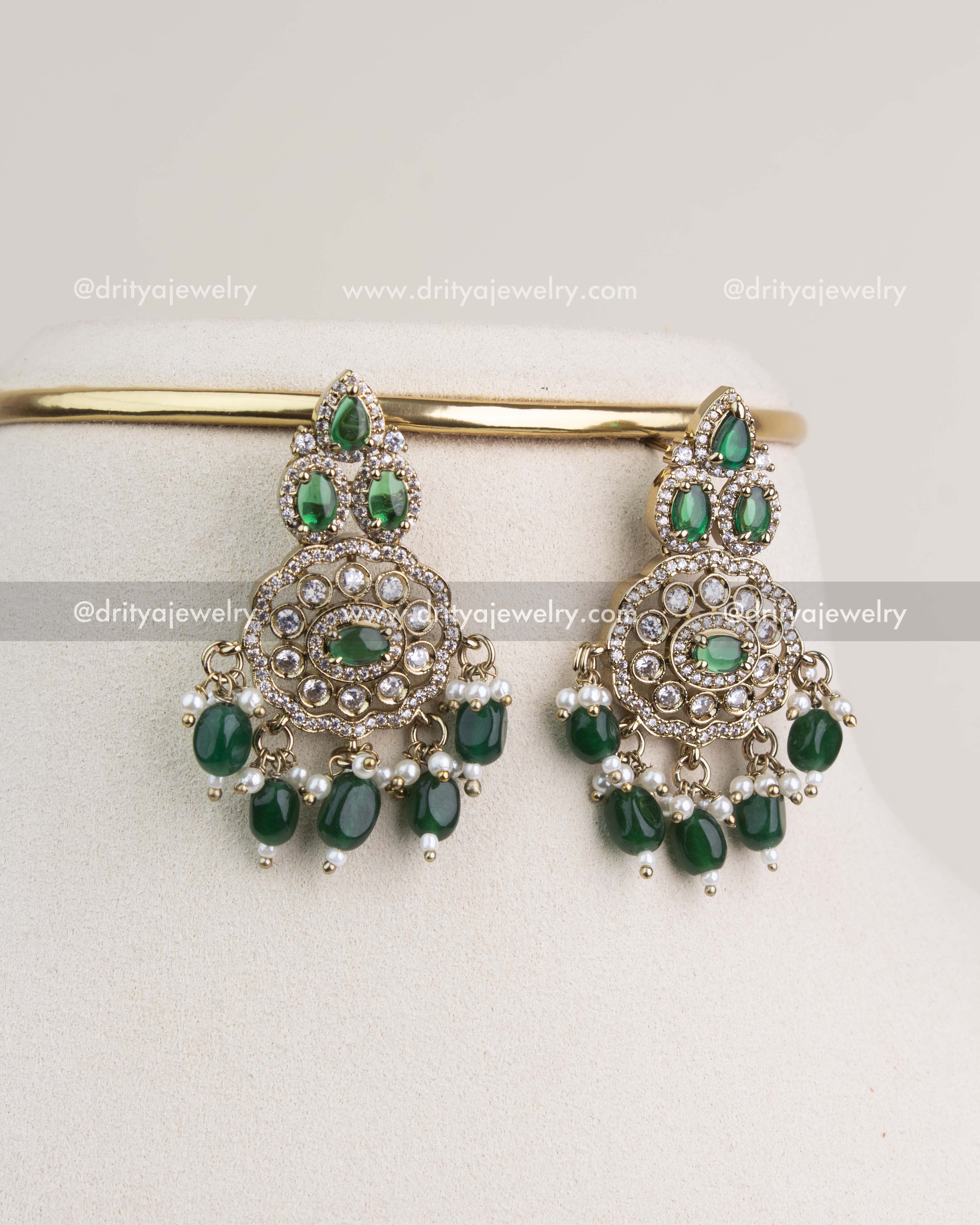 Matching Victorian-style earrings with emerald green stones and mini pearl drops.