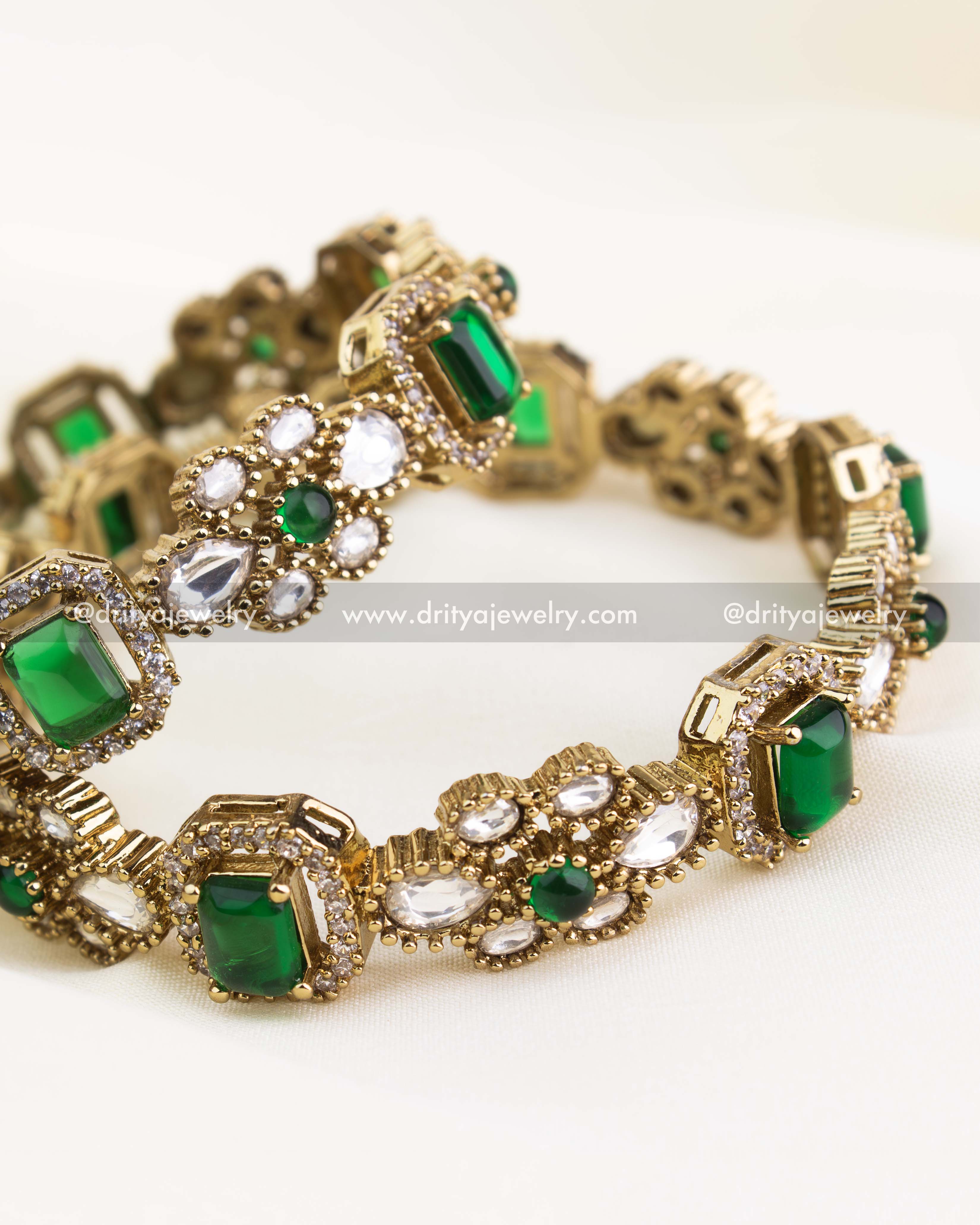 Premium gold-plated Victorian bangles with emerald green rectangular stones and polki kundan setting.