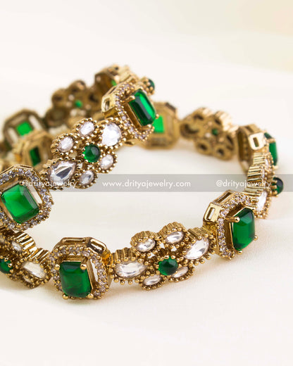 Premium gold-plated Victorian bangles with emerald green rectangular stones and polki kundan setting.