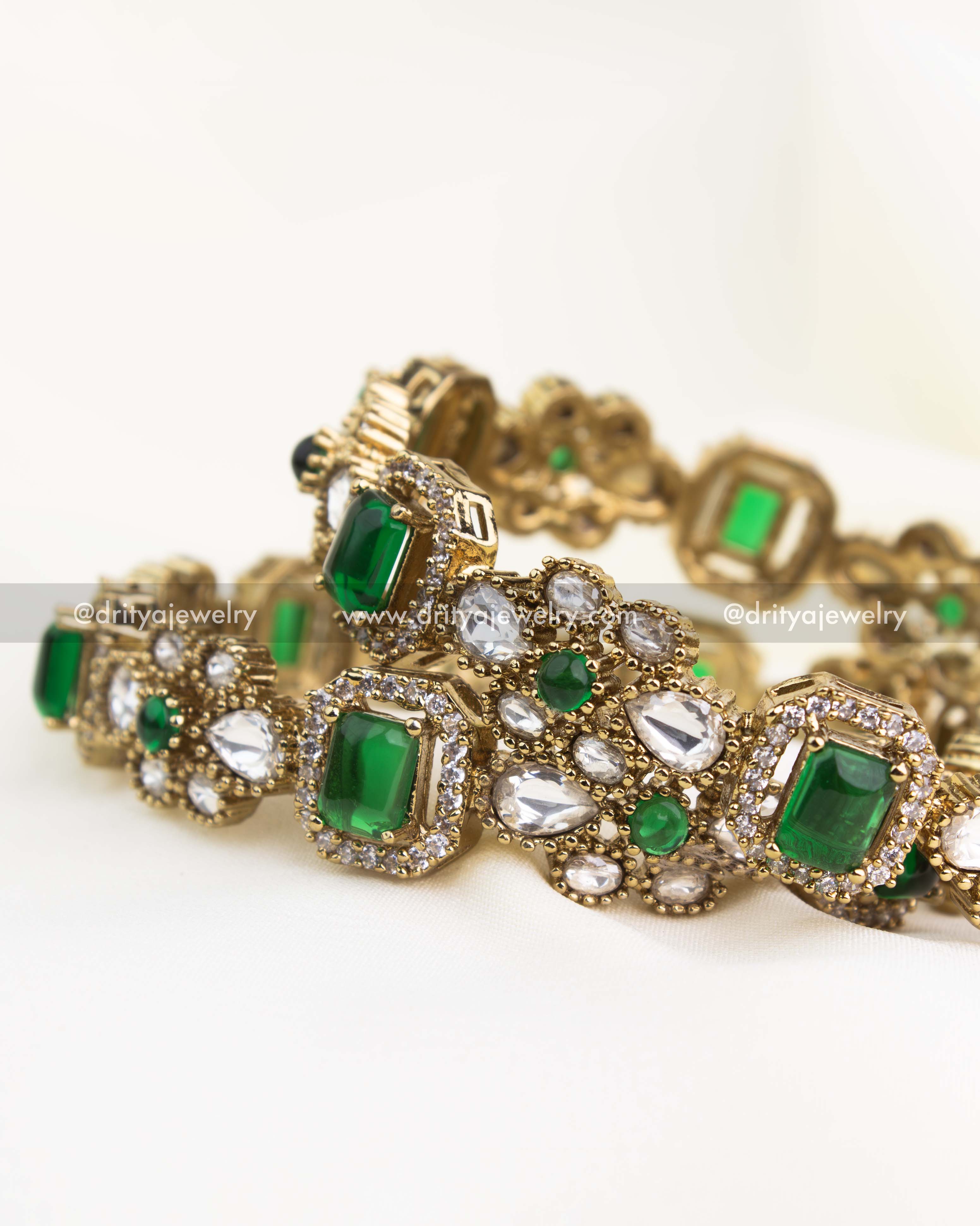 Premium gold-plated Victorian bangles with emerald green rectangular stones and polki kundan setting.