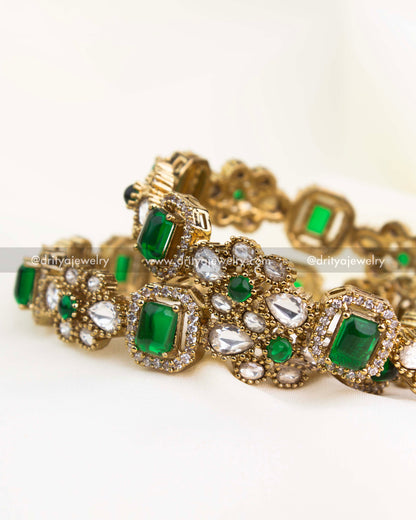 Premium gold-plated Victorian bangles with emerald green rectangular stones and polki kundan setting.