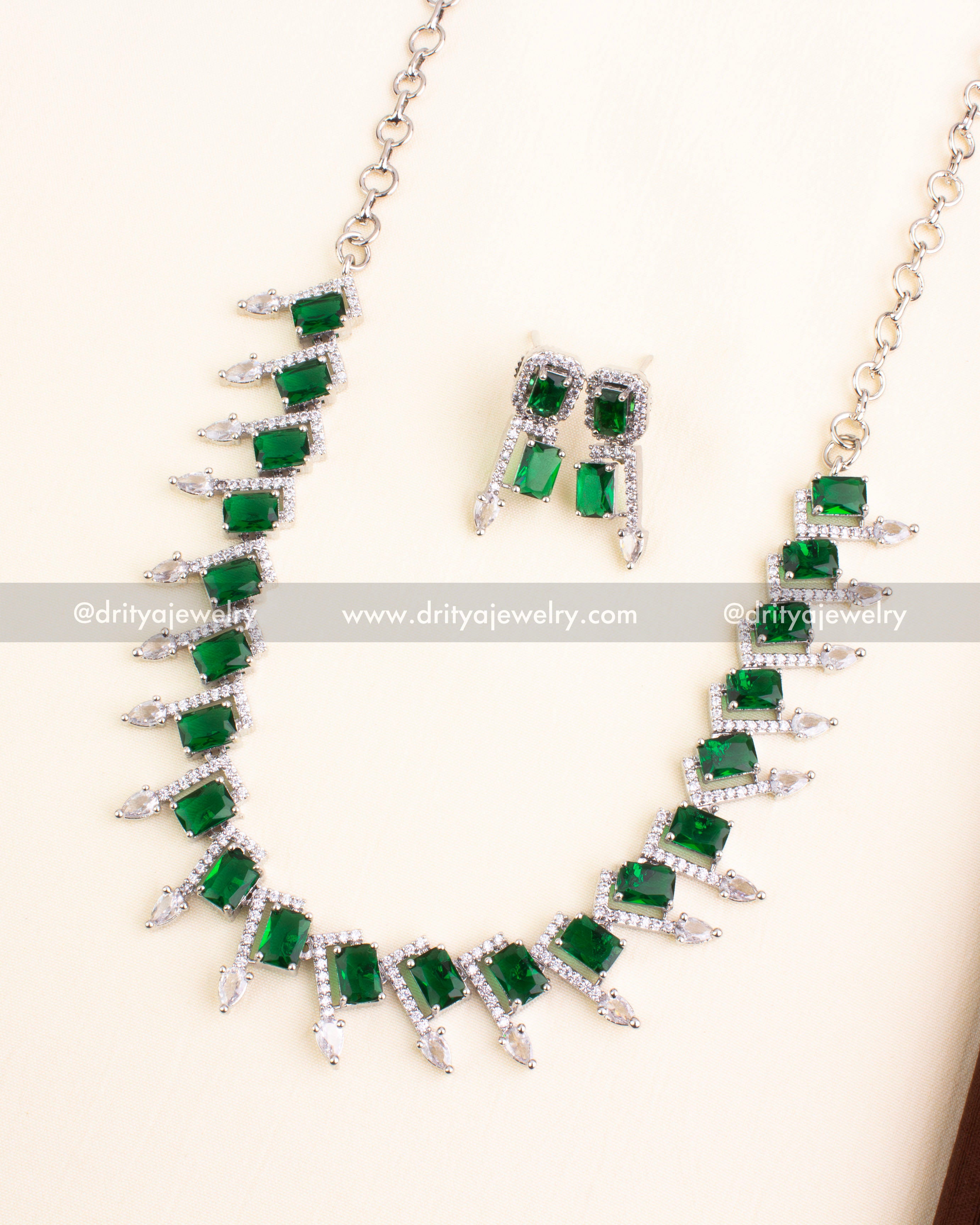 Silver-finished necklace with emerald green rectangular stones and American Diamonds