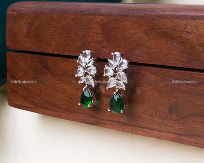 Elegant emerald zircon dangler earrings with white marquise zircon stones and a polished silver-tone finish.