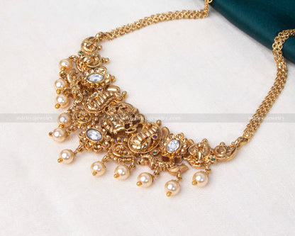 Elegant gold choker encrusted with gemstones and adorned with pearls, perfect for bridal wear and formal occasions.