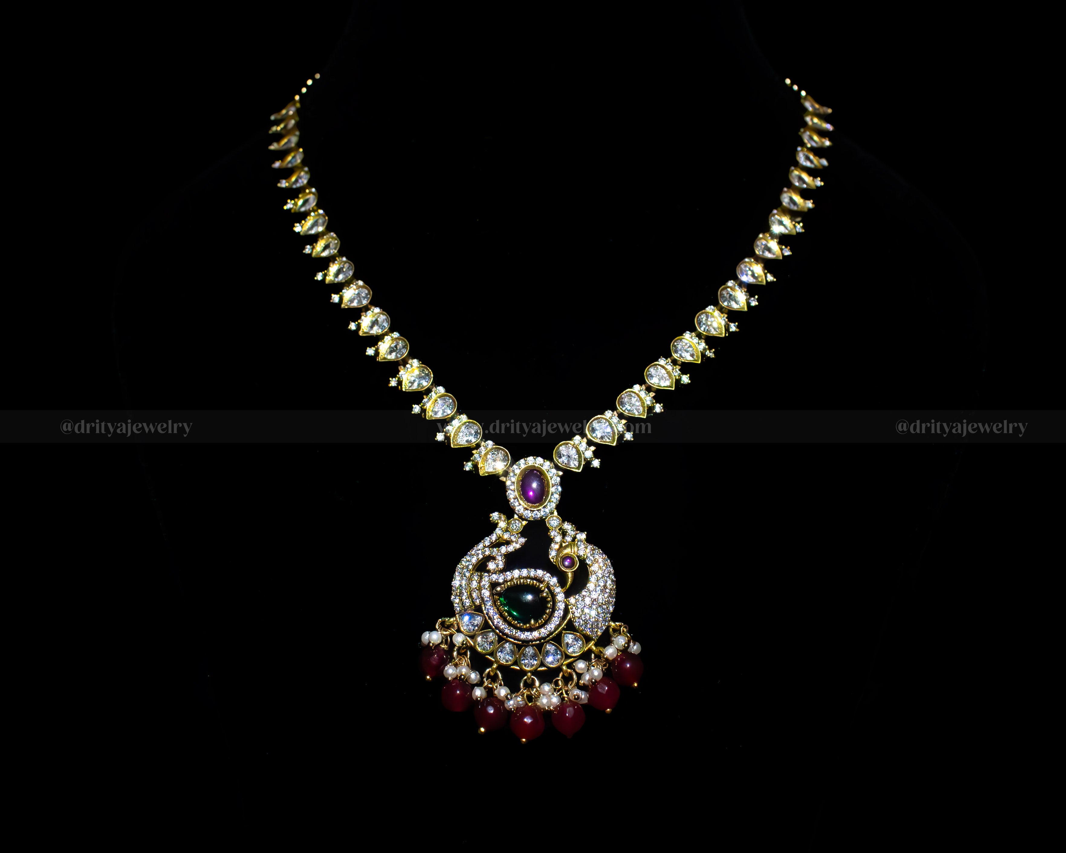 Front view of the Mehndi Victorian Necklace Set by Dritya Jewelry, adorned with emerald, ruby stones, and a teardrop crystal chain.