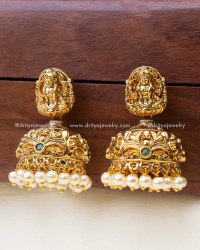 Front view of premium nakshi small Jhumka earrings with antique finish and pearl drops.