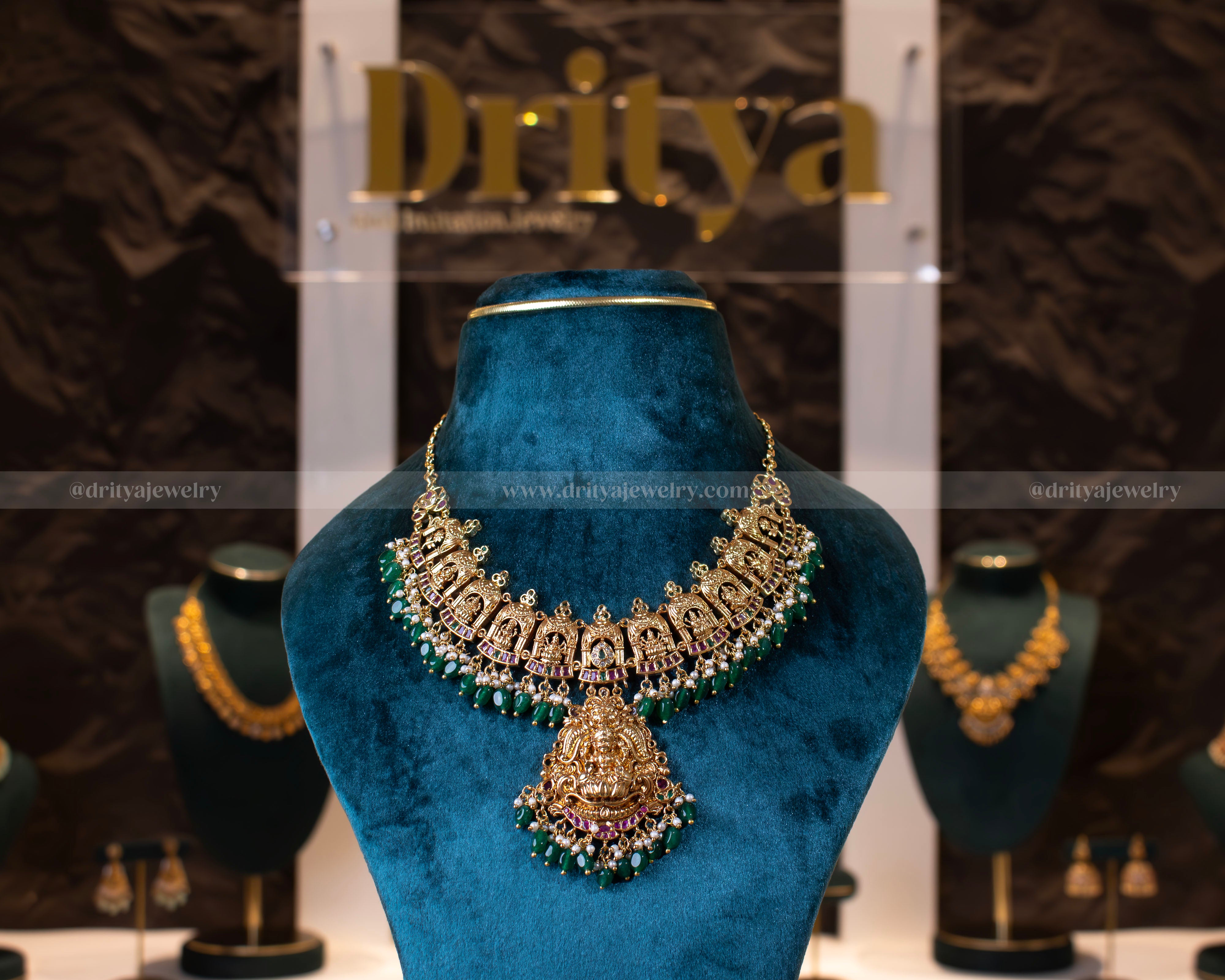 Front view of the temple necklace from Dritya Jewelry, highlighting the intricate temple motifs and the regal Lakshmi pendant.