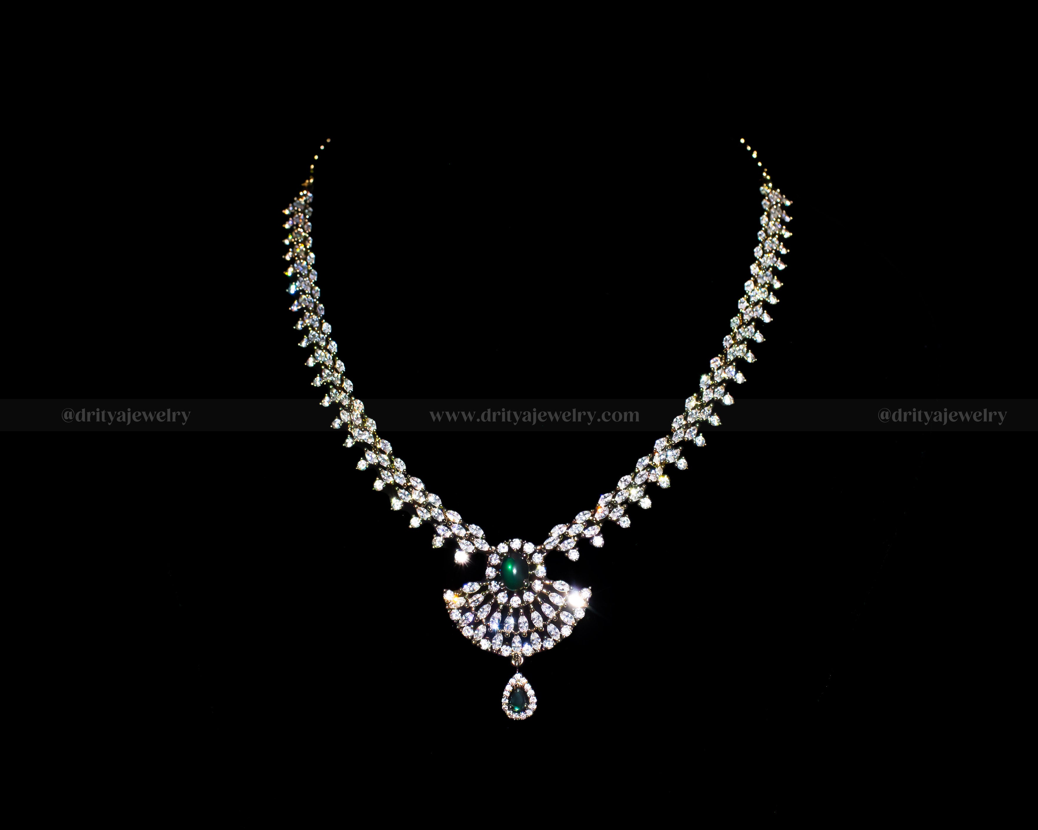 Front view of the Victorian Necklace Set by Dritya Jewelry, adorned with sparkling CZ stones and a green gemstone pendant.