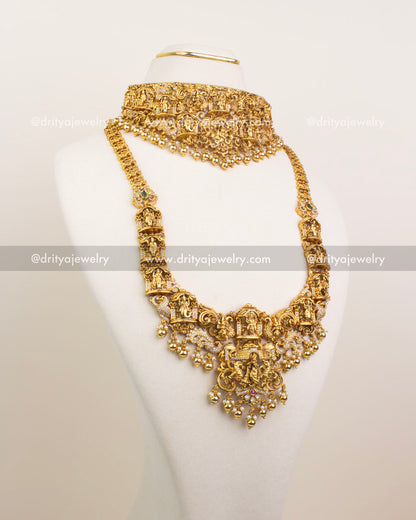 Full view of antique gold Krishna motif bridal set with choker, long necklace, and earrings