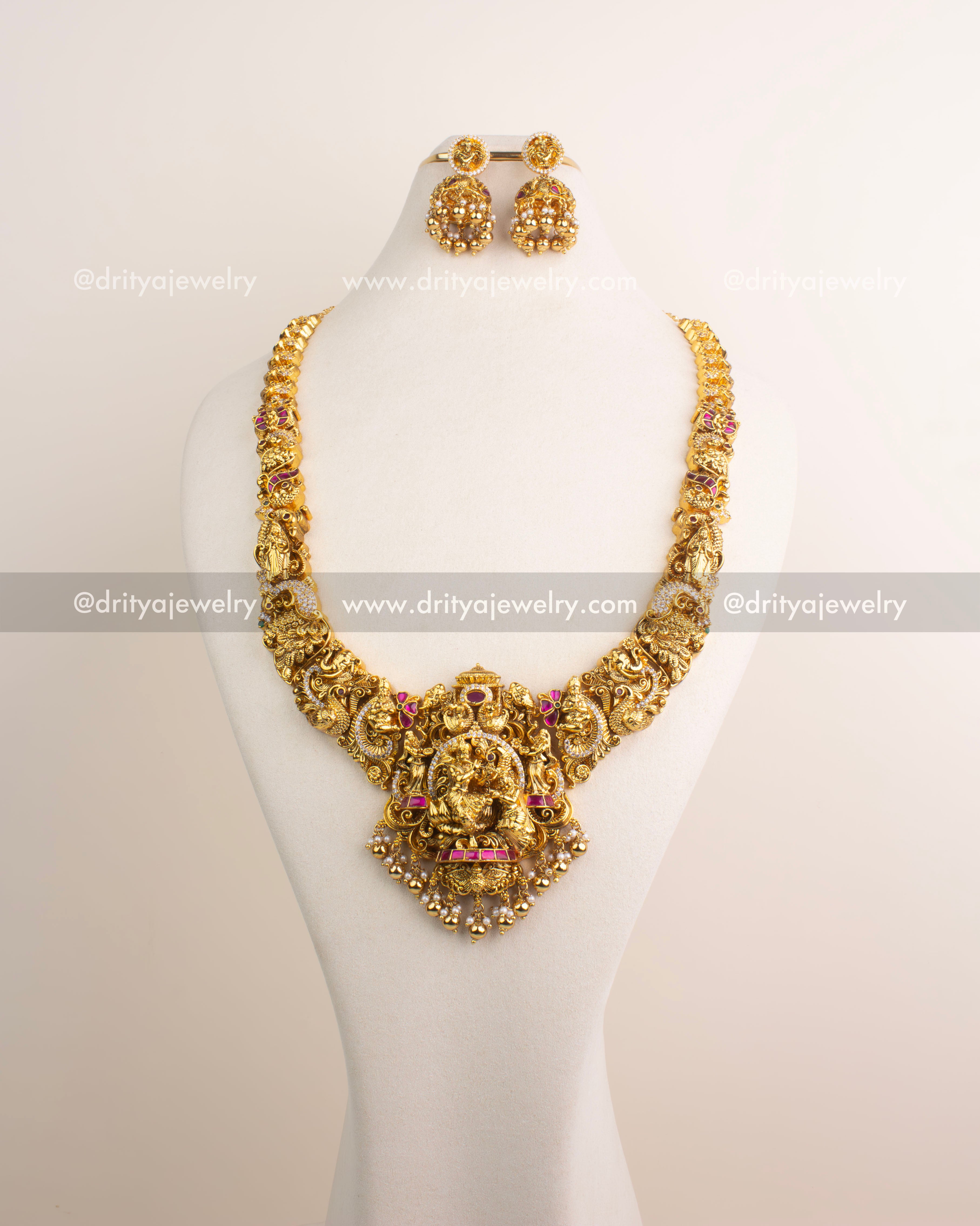 Temple jewelry long necklace with detailed Nakshi work and divine pendant.