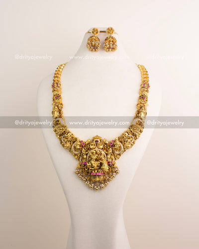 Temple jewelry long necklace with detailed Nakshi work and divine pendant.