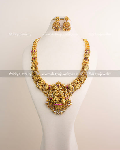 Temple jewelry long necklace with detailed Nakshi work and divine pendant.