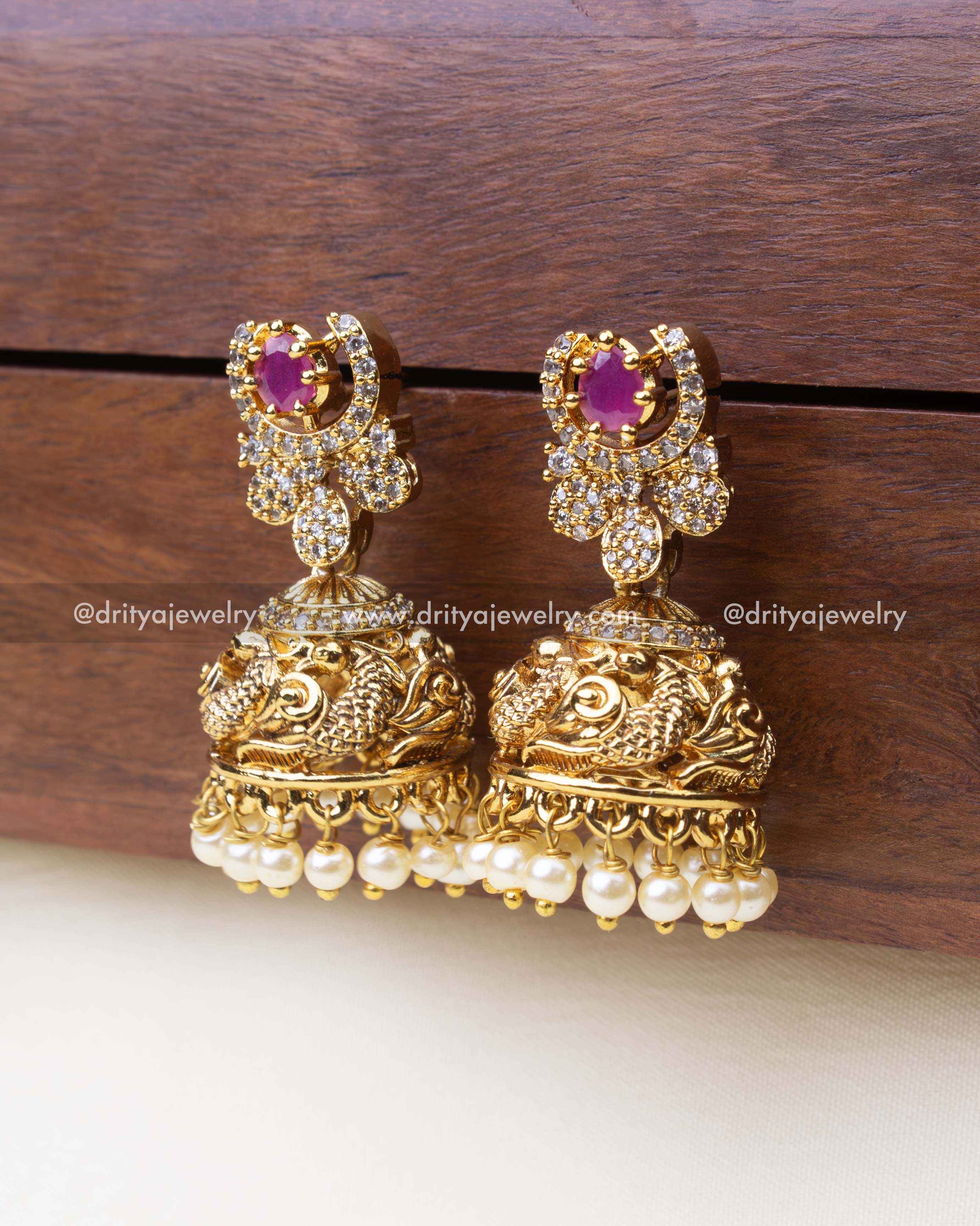 Antique earrings with antique gold polish, pink center stone, and CZ accents.
