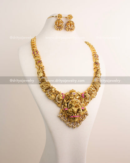 Temple jewelry long necklace with detailed Nakshi work and divine pendant.
