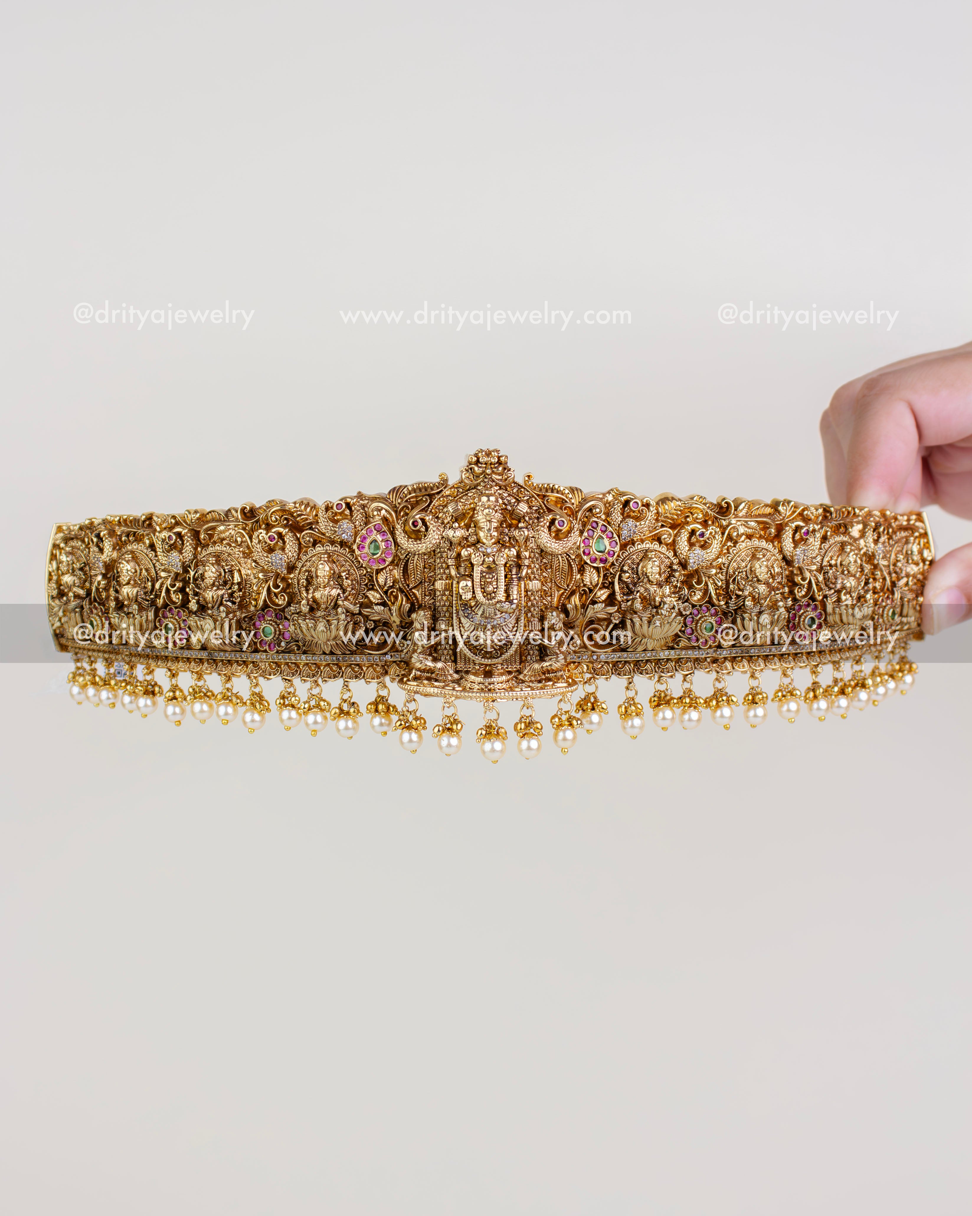 Full front view of antique gold Venkateshwara waist belt with pearl hanging fringe.