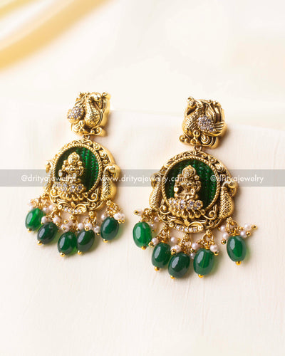 Detailed view of Lakshmi earrings with green beaded backdrop and hanging green beads.